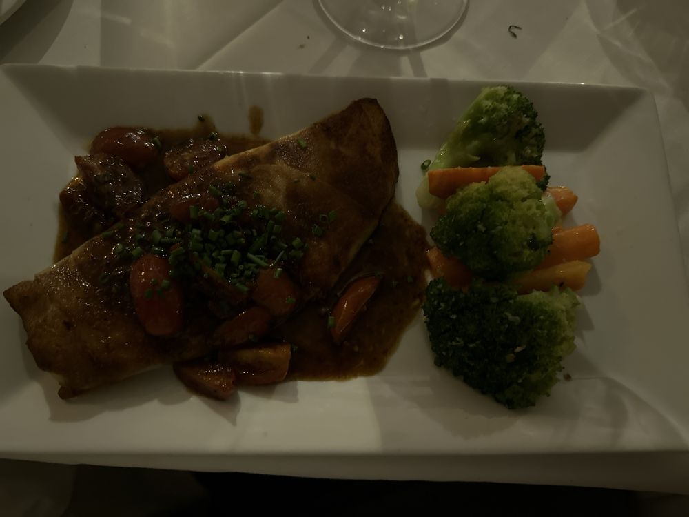 Fish in brown sauce with cherry tomatoes